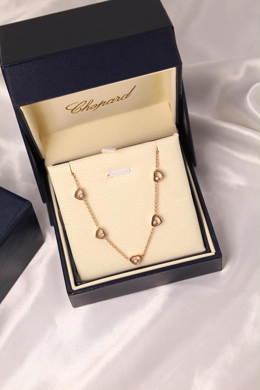 Chopard Happy Diamonds Happy Hearts Five-Heart Necklace — with Floating Diamond Details.