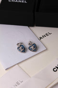 CHANEL – Blue Heart CC Crystal Earrings