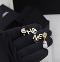 CHANEL – Gold Letter Drop Earrings with Pearl Accents
