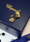 Chopard Happy Diamonds Heart Stud Earrings — White-Tone Metal with Three Floating Stones and Pavé-Set Heart Borders.