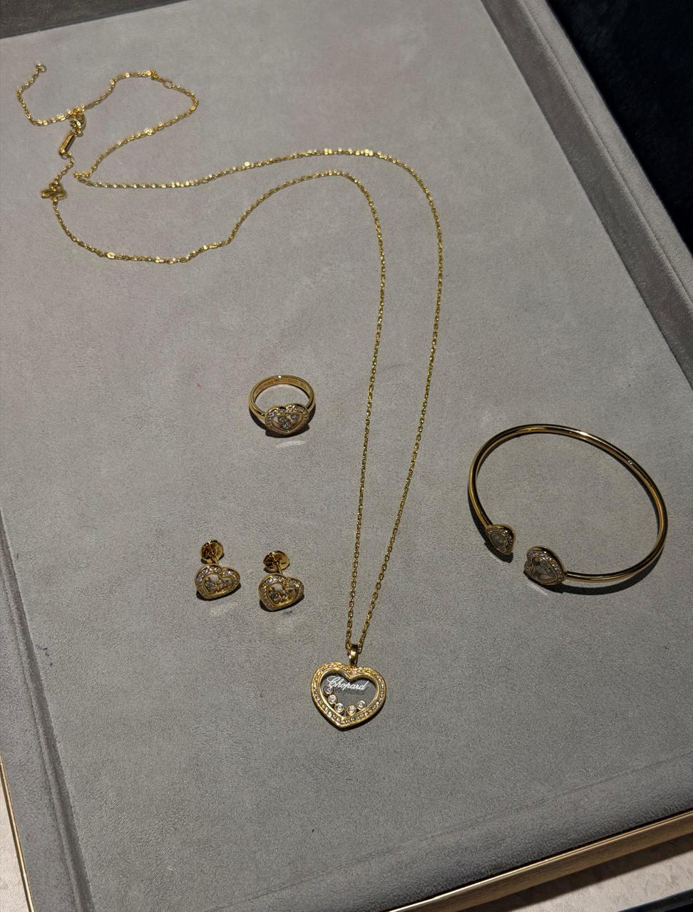 Chopard Happy Diamonds Heart Four-Piece Jewelry Set — -Tone Necklace, Ring, Stud Earrings & Open Cuff Bracelet with Floating Stone Details and Pavé-Set Heart Borders.